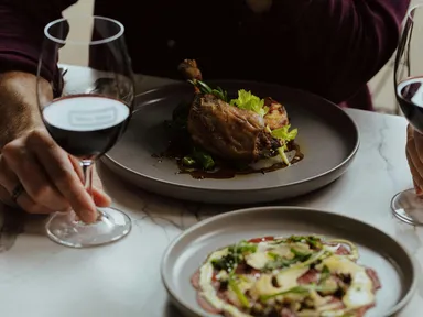 Delight in a crispy confit duck leg served with gratin potato and broccolini, perfectly paired with their new release 2023 Flower Vineyard Grenache.